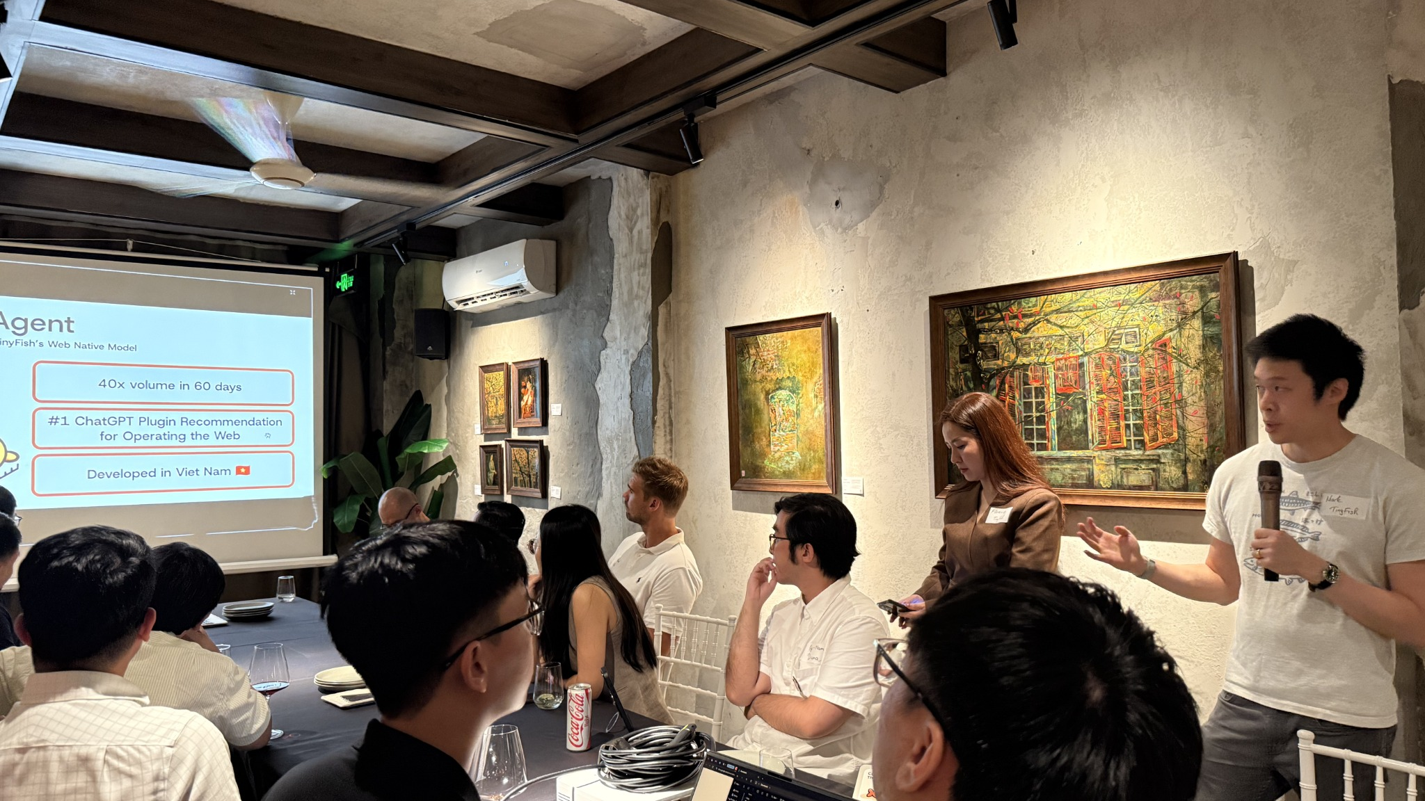 TinyFish presentation with attendees gathered around the table at TinyFish, Big Minds in Vietnam.